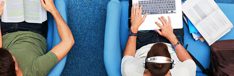 Aerial view of people using their laptop and reading books