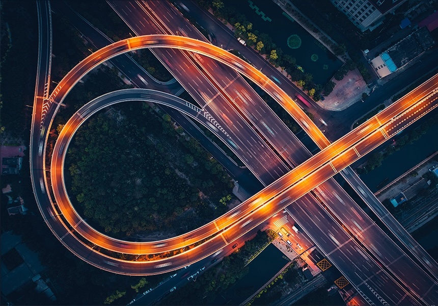 Aerial view of a brightly lit highway interchange at night