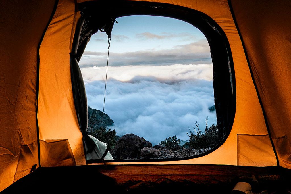 Image of clouds from perspective of inside a tent
