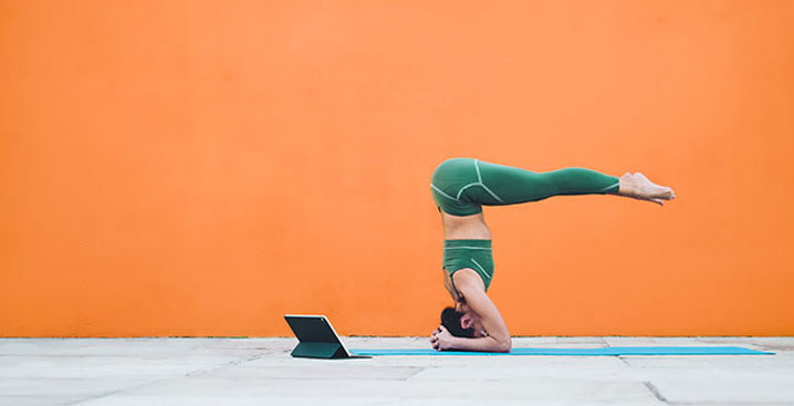 Woman doing yoga on an orange background