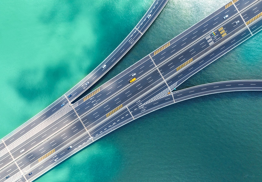 An overhead view of a highway over a body of water