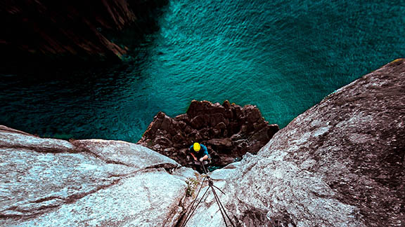 Man scaling a cliff