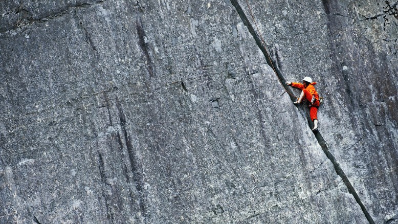 A person scaling a cliff