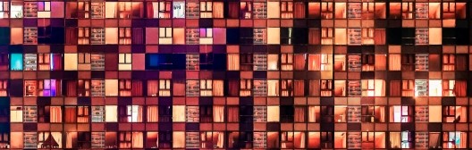 windows glowing at night, symbolizing data and portfolio construction