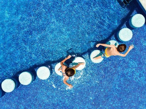 Children running in the pool