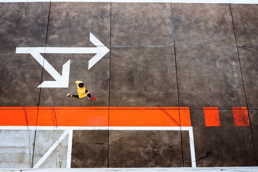 Man in yellow jacket running to the right.