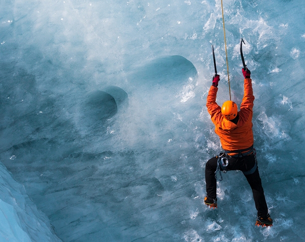 man climbing ice mountain