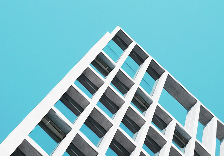 A building standing against a clear blue sky, having vibrant atmosphere.