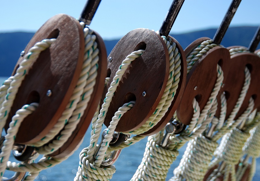 Rope with wooden pulley in a ship image