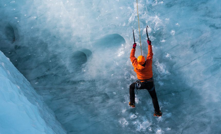 man climbing on ice rock