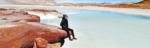 Boy sitting on rock