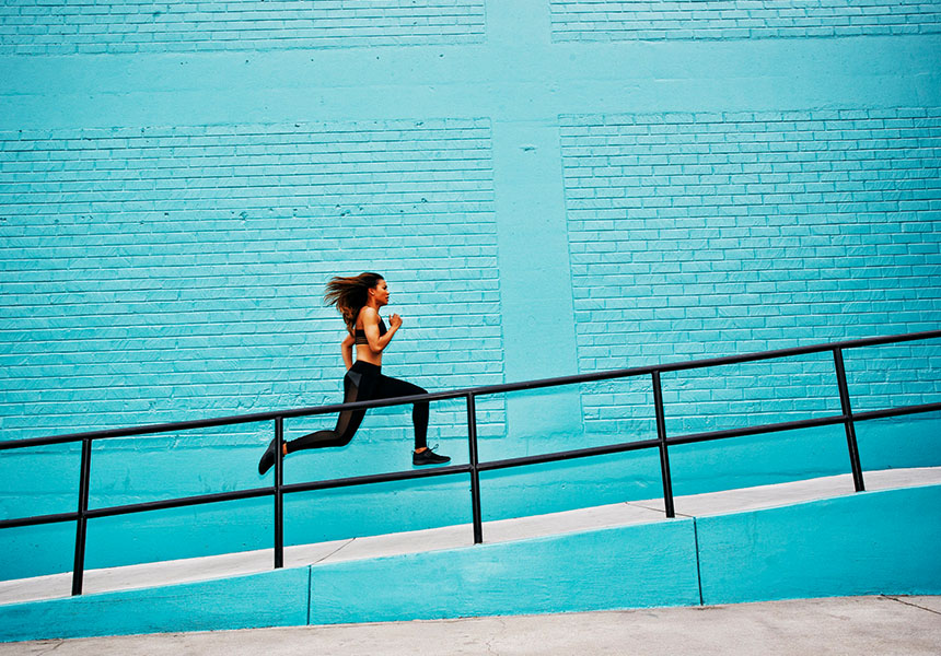 Woman runs up a staircase