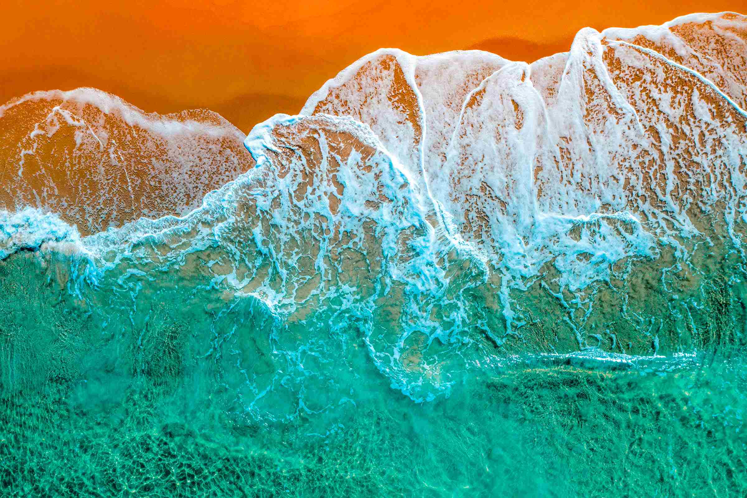 Yellow sand seashore with green water