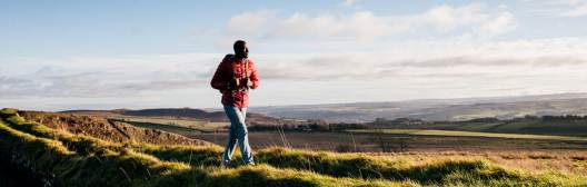 image alt text is: A man overlooks a valley from a hill, considering options for navigating his retirement income effectively.