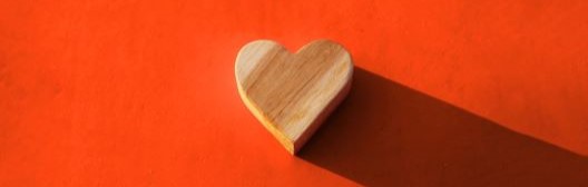 Wood heart on red background