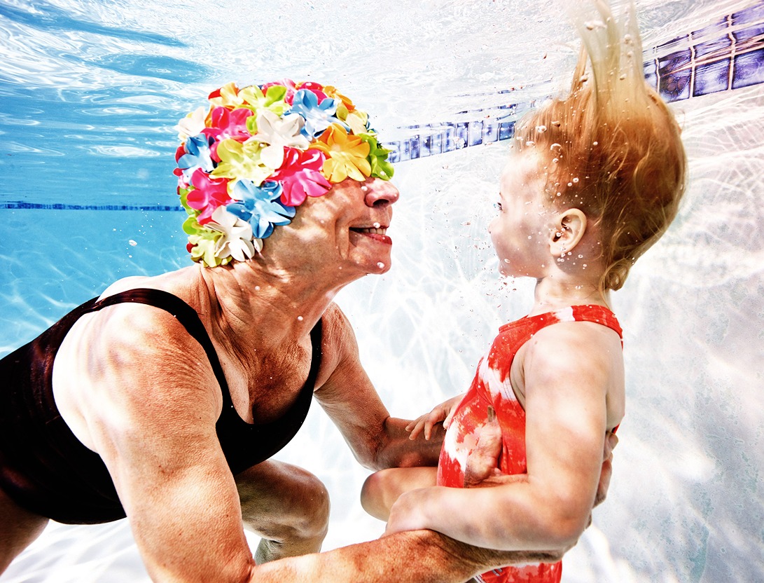 women and baby in swimming pool