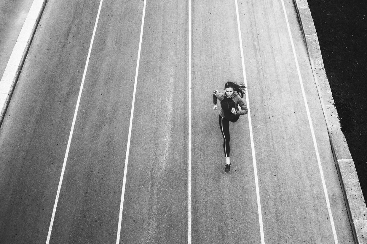 Women running in the middle of the road