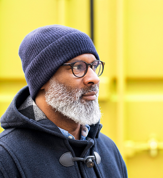 Man with glasses and a beard wears a beanie