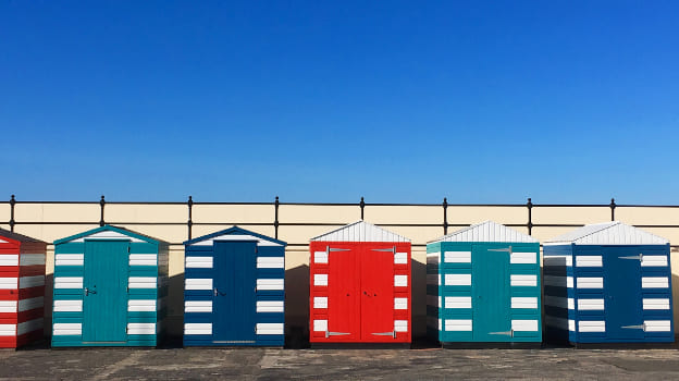 Photograph of a row of colorful beach huts