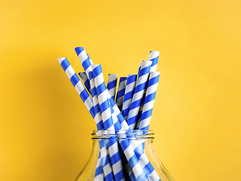 Blue straws in glass